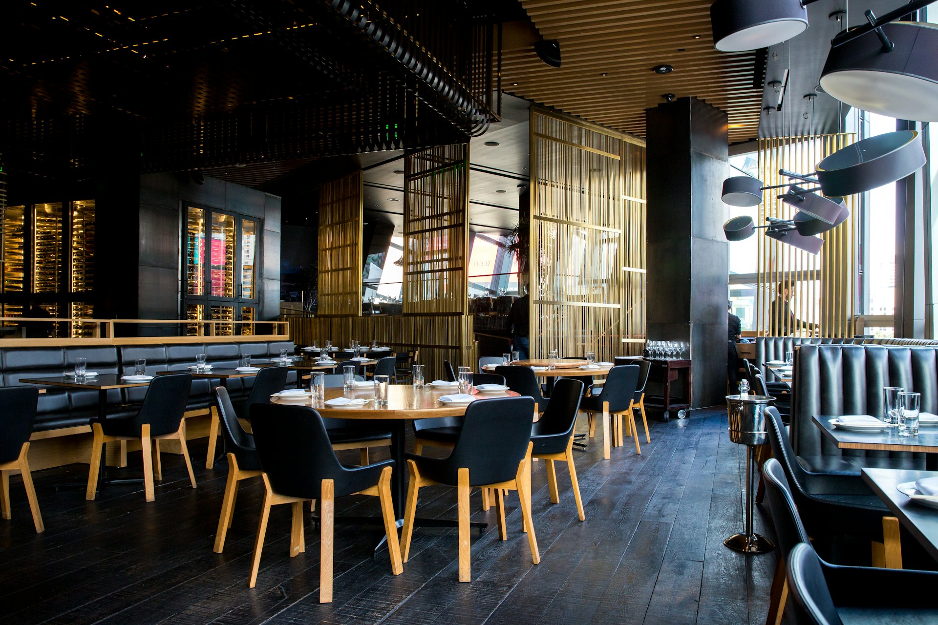 cinematic shot of an empty upscale dark luxury restaurant interior, moody lighting, modern architecture, 8k resolution, highly detailed